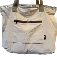 Beige tote bag with Peanuts trim.