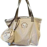 Beige tote bag with Snoopy design.