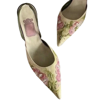 Floral embroidered pointed-toe heels.