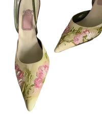 Floral embroidered pointed-toe slingback heels.