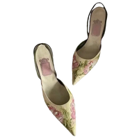 Floral embroidered slingback heels.