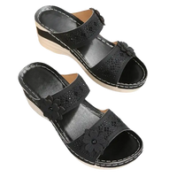 Black floral embellished wedge sandals.