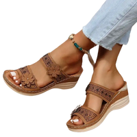 Brown floral-accented wedge sandals.