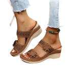 Brown floral-accented wedge sandals.