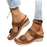 Brown floral-accented wedge sandals.