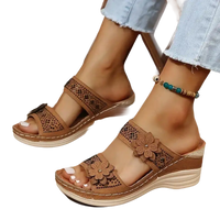 Brown floral-accented wedge sandals.