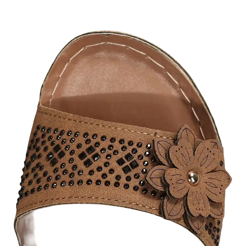 Brown sandal with flower embellishment.
