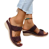 Burgundy floral-embellished wedge sandals.