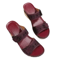 Burgundy floral-accented wedge sandals.