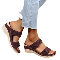 Burgundy floral-accented wedge sandals.