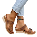 Brown floral-accented wedge sandals.