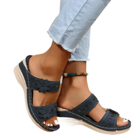 Navy blue floral-embellished wedge sandals.