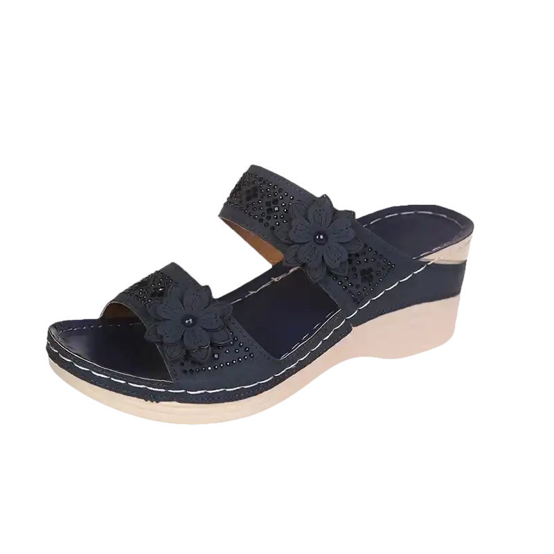 Navy wedge sandal with floral embellishments.