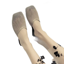 Beige mesh mules with floral stockings.