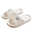White bear-patterned slide sandals.