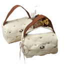 Two quilted handbags with brown handles.