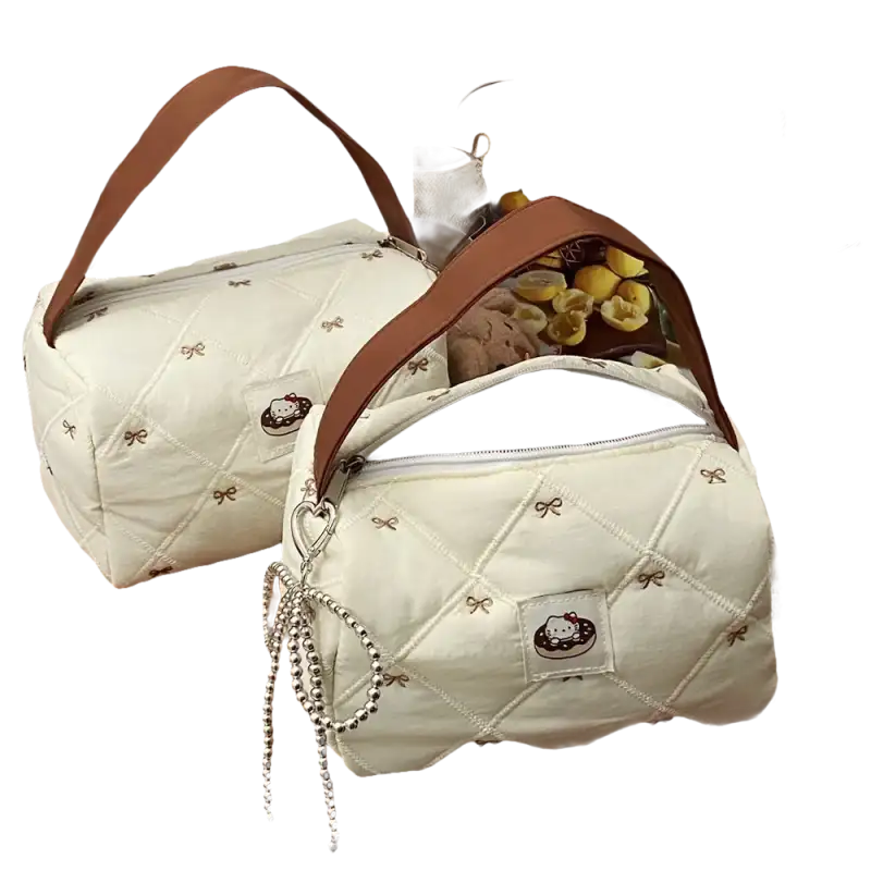 Two quilted handbags with brown handles.