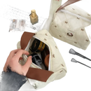 Quilted cosmetic bag with bow pattern.