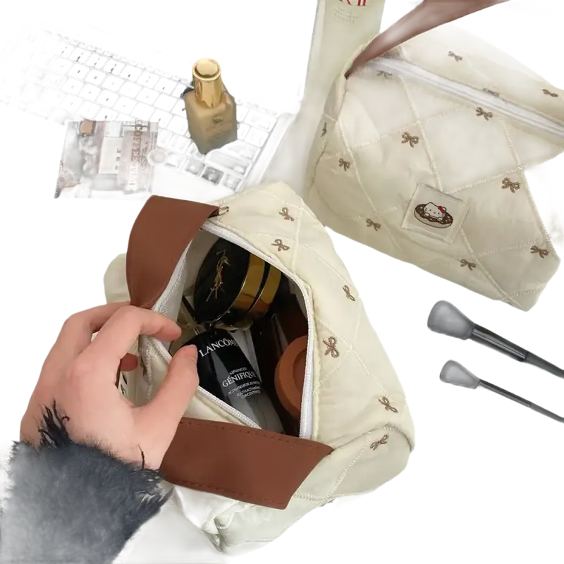 Quilted cosmetic bag with bow pattern.