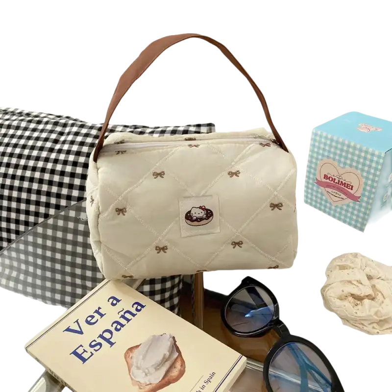 Quilted cream-colored handbag with brown handle.