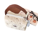 Quilted handbag with brown handle.