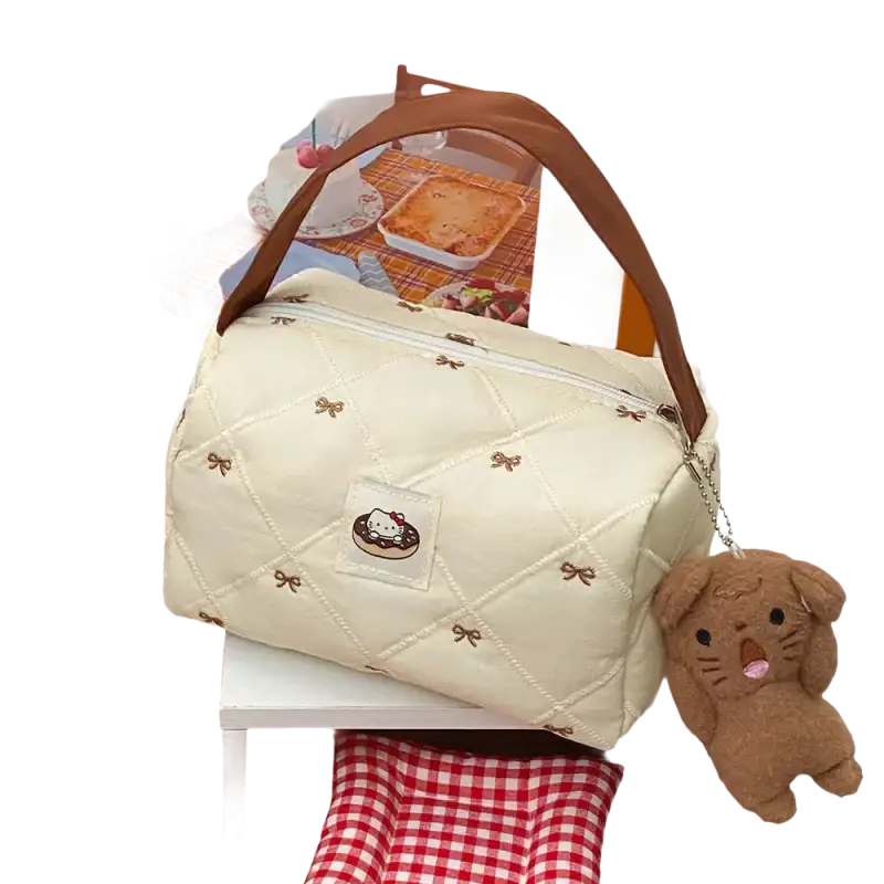Quilted cream-colored handbag with brown handle and dog keychain.