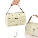 Quilted cream-colored handbag with brown straps.