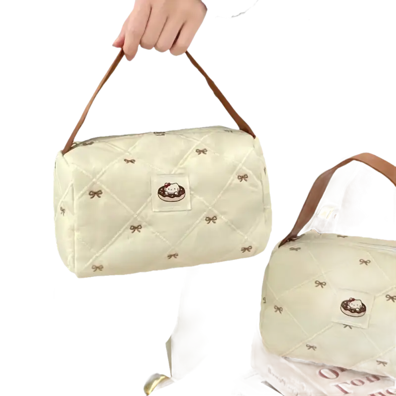 Quilted cream-colored handbag with brown straps.