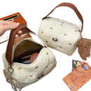 Quilted cream-colored handbag with brown handle.