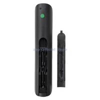 Black remote control with battery compartment open.