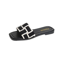 Black and white woven slide sandal.