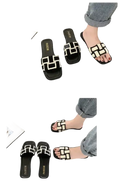 Black and white patterned slide sandals.