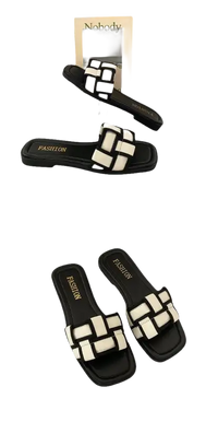 Black and white woven slide sandals.
