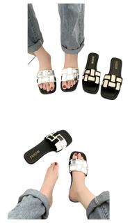 Black and white woven slide sandals.