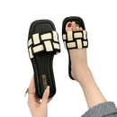 Black and white woven slide sandals.
