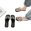 Black and white woven-strap sandals.
