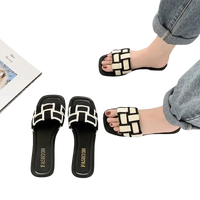 Black and white woven-strap sandals.