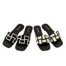 Four black and white woven slide sandals.