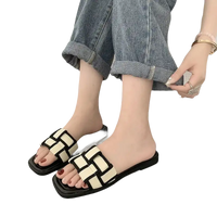 Woven black and white slide sandals.