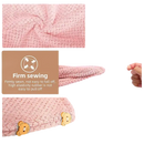 Pink microfiber hair towel with button closure.