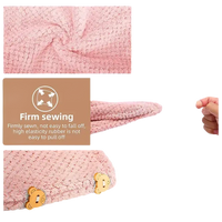 Pink microfiber hair towel with button closure.