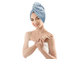 Woman wearing a blue towel turban.