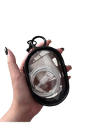 Black-rimmed clear case holding a white charger and cable.