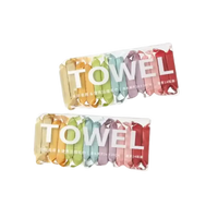 Two boxes of colorful, individually wrapped towels.