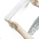 White fabric held by hands.