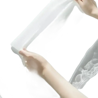 White fabric held by hands.