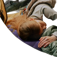 Sleeping woman in tent with campcomfort inflatable neck pillow for outdoor camping adventure