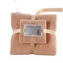 Stacked beige towels with ribbon from Trendy Coral Bath Set Towel Shenanigans, highly absorbent and stylish