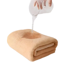 Folded tan towel from Trendy Coral Bath Set Towel Shenanigans being soaked, highly absorbent 2pc bath towels set