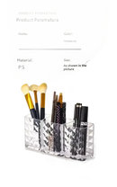 Transparent makeup brush holder in a diamond chic bathroom with a trendy patterned mirror cabinet